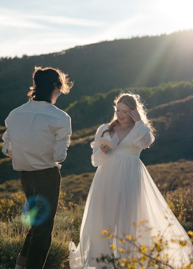 The bride reading her vows to the groom during sunset during their Crested Butte Elopement