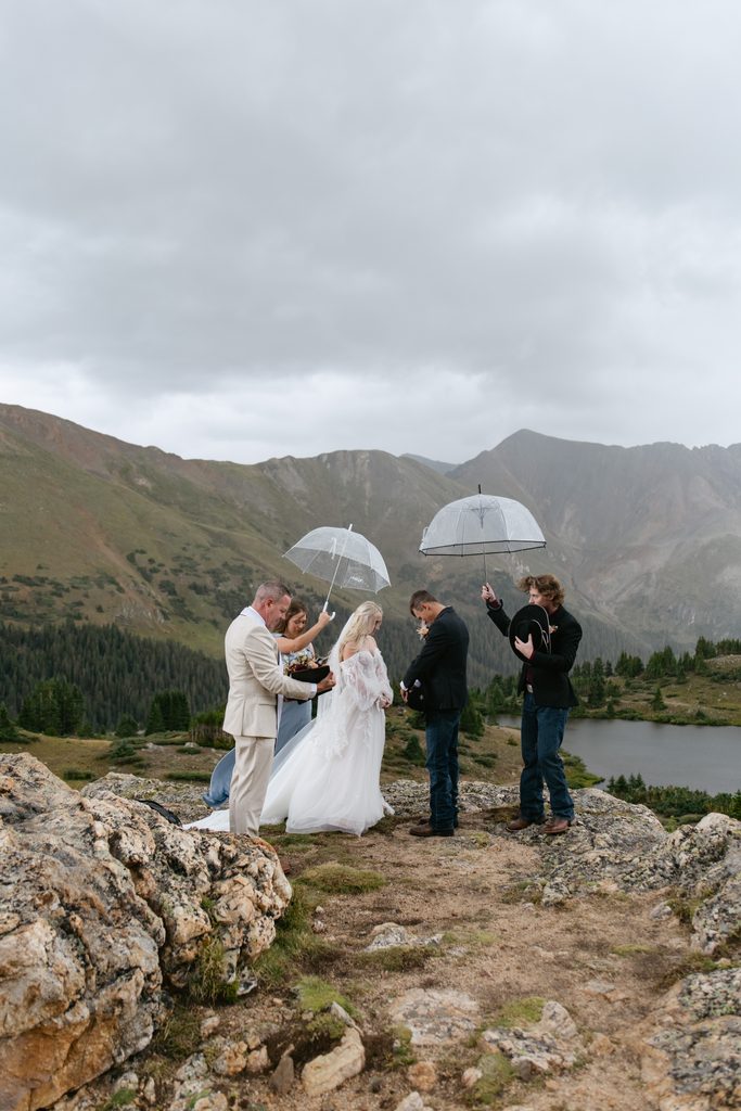 an elopement taking place in the rain at Pass Lake
